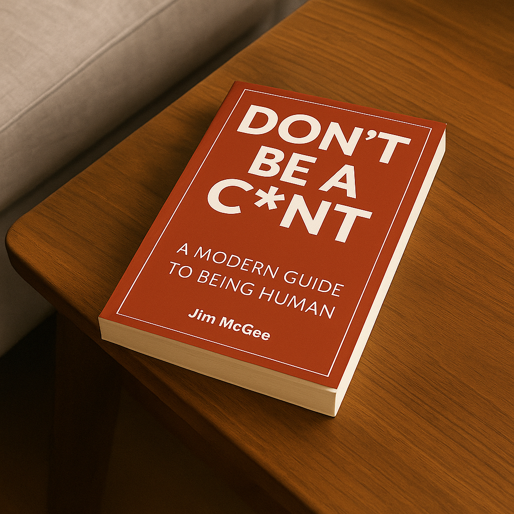 Don't Be a C*nt by Jim McGee, photographed on a wooden table